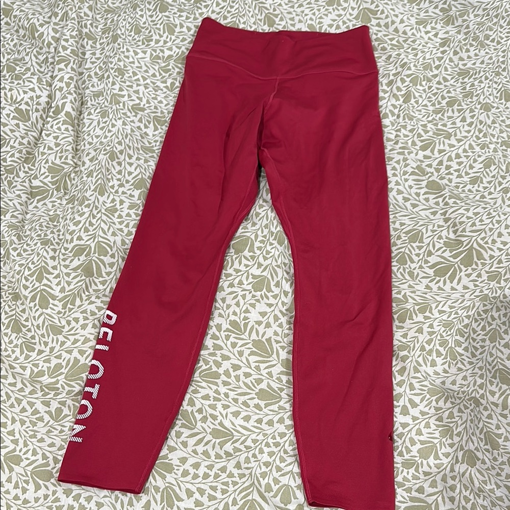 Garnet Nike Dri fit leggings with “Peloton” on side